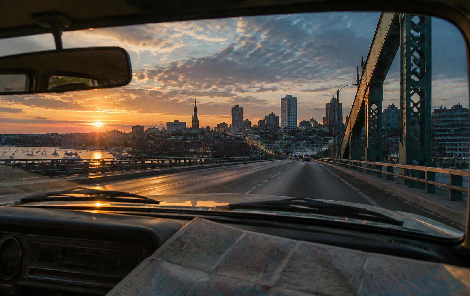 Road view approaching an American city at sunrise